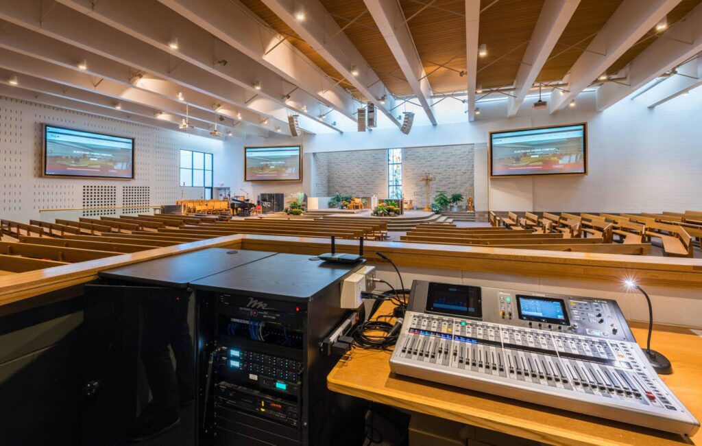 Mixing console and speakers in a house of worship