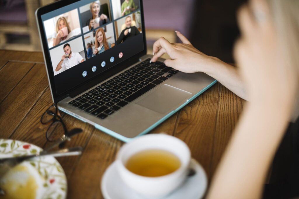 Person drinking coffee while on a video call