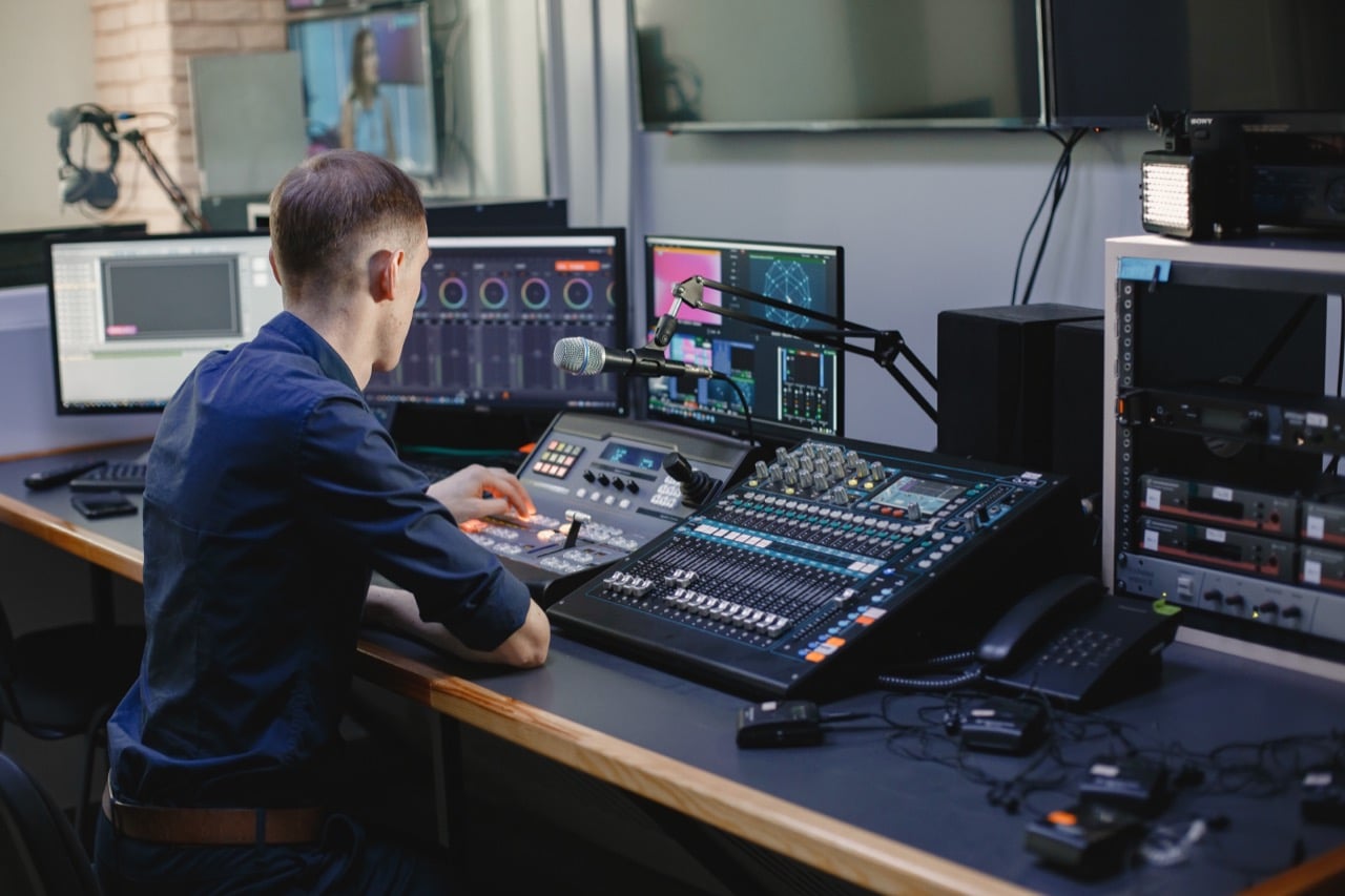 Sound engineer working in studio with equipment